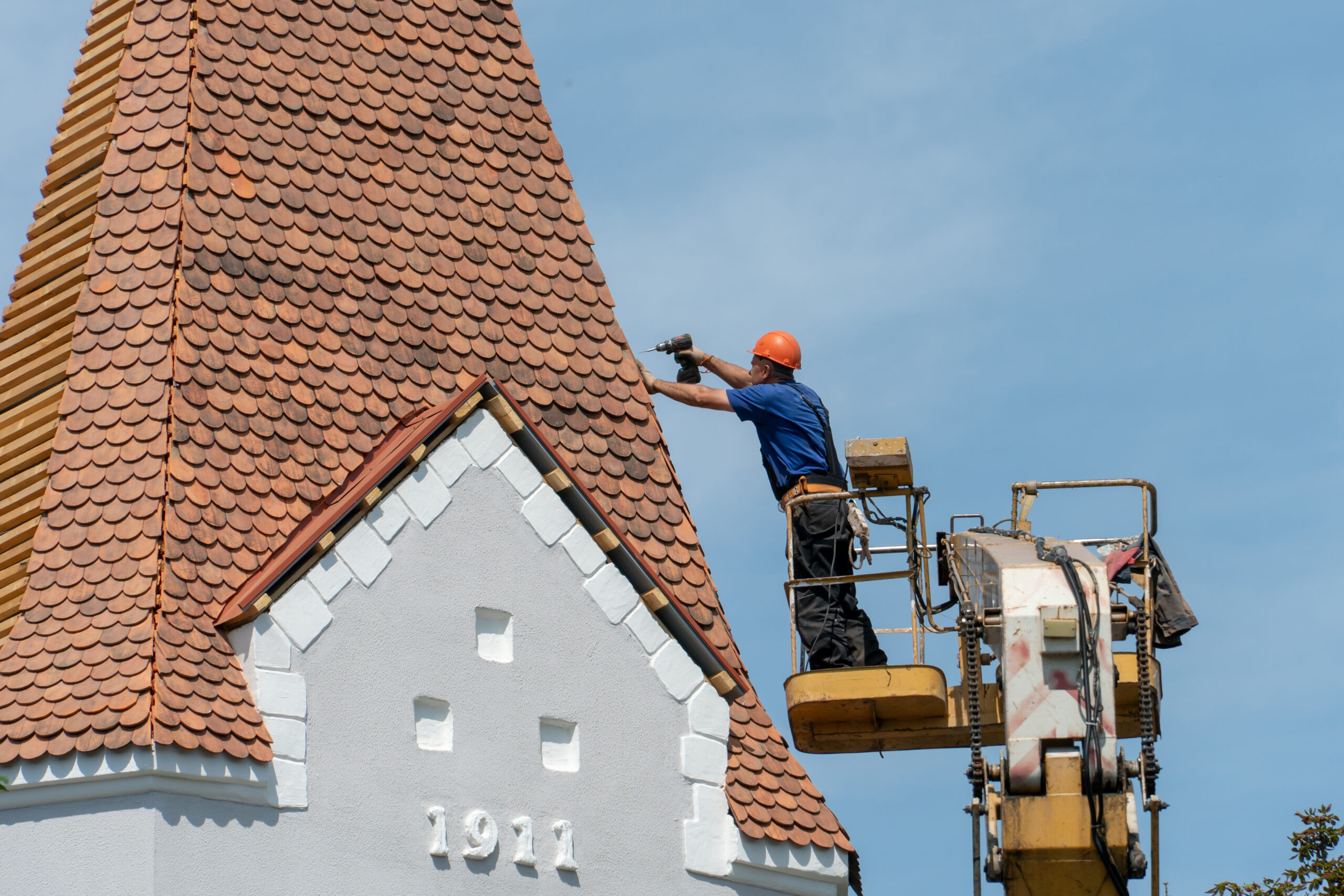 A worker carefully repairing and reinforcing the church roof, ensuring its stability and protection for years to come.